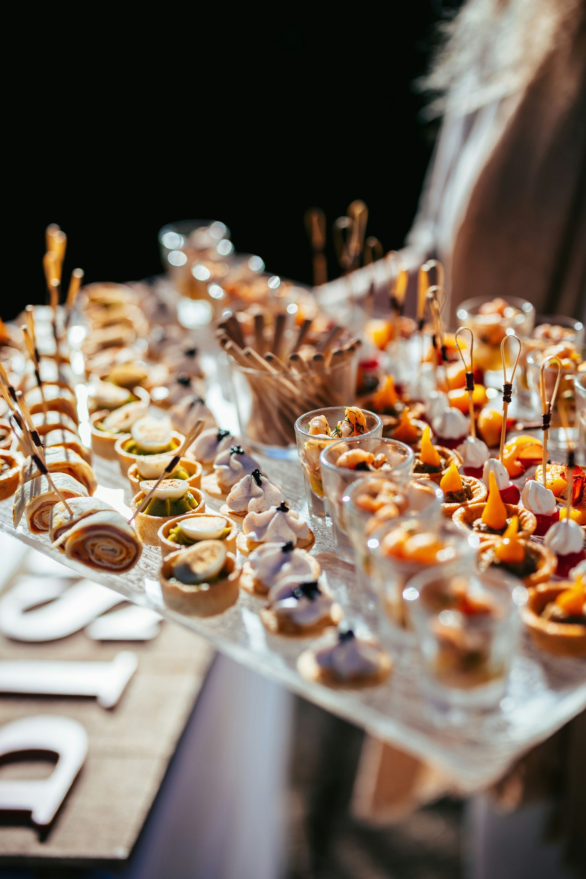 A table topped with lots of food on top of a wooden table