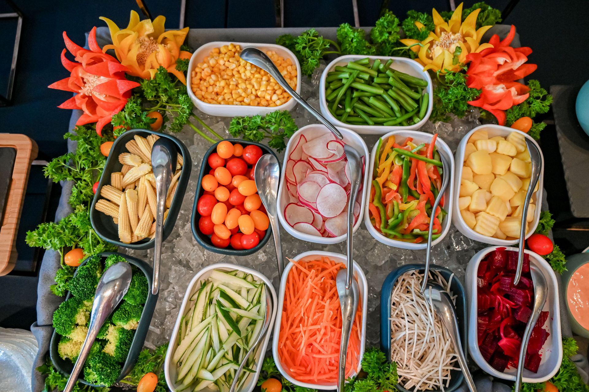 An assortment of fresh vegetables displayed in a colorful salad bar arrangement.